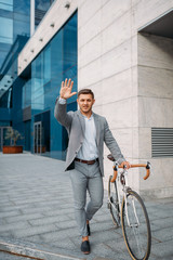 Businessman cyclist, glass building on background