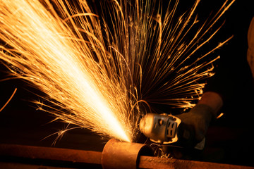 Closeup view of hot sparks while cutting metal by grinder