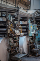 Old Printing press with rolls of paper