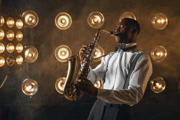 Black jazz performer plays the saxophone on stage