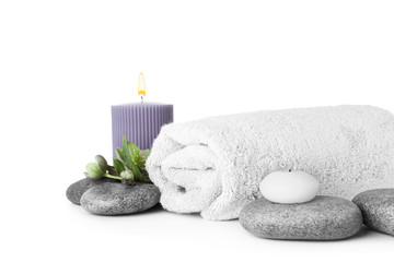 Obraz na płótnie Canvas Composition with spa stones, towel and candles isolated on white