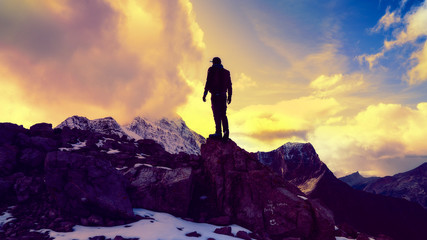 Dramatic Man Standing On Top Of Mountain Peak Success Concept