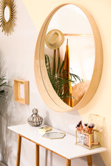 Stylish room interior with little table and mirror