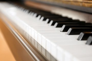 Black and white piano keys indoors, closeup