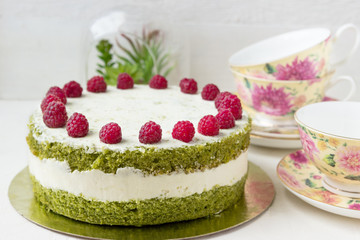 Delicious birthday cake with spinach and raspberries.