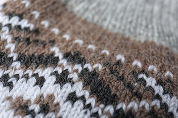 Knitted soft woolen sock as background, closeup
