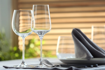 Table setting with empty wine glasses and napkin