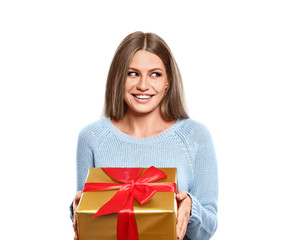 Young woman with Christmas gift on white background