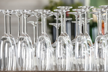 Empty glasses on wooden table against blurred background