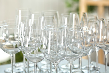Empty glasses on table against blurred background, closeup