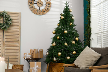 Beautiful decorated Christmas tree in living room interior