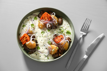 Tasty dish served on light table, flat lay