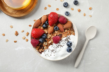 Tasty homemade granola served on marble table, flat lay. Healthy breakfast