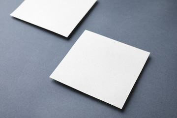 Blank note papers on dark grey background. Mock up for design