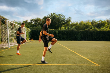 Two male soccer players training on the field