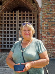 Pensive Mature plump woman walks the streets of the city