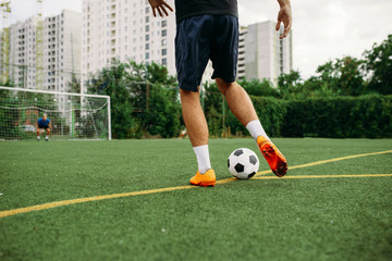 Male soccer player working with ball on the field