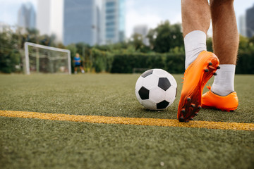 Male soccer player working with ball on the field