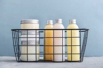 Bottles with spa cosmetic products in  metal basket