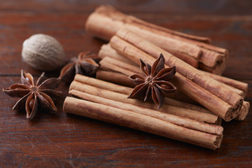 Star anise with cinnamon. Christmas spices on rustic wooden background. Close up. 