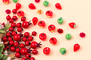 Beautiful autumn background, artificial miniature apples and red rosehip berries
