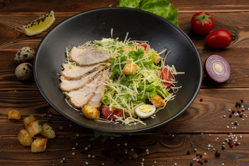Caesar San Salad of Romano leaves, chicken, cherry tomatoes, egg, breadcrumbs, Parmesan cheese, Caesar sauce and tobiko