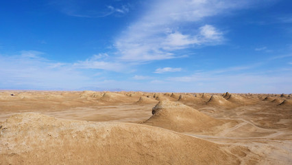 Fototapeta na wymiar Beautiful landscape view of Yardang landform and sunny blue sky in Dunhuang Gansu China