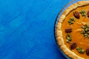 Obraz na płótnie Canvas Tasty pumpkin pie, tart made for Thanksgiving day in a baking dish Top view.
