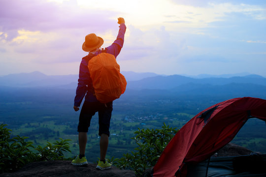 Backpacker,Tourists Raise Your Fist Above Your Head Enjoying The Nature, The Mountain With Nature During Sunset.tent