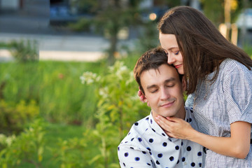 Loving man and woman having sweet tender moment together, happy millennial couple smile caressing each other, young husband and wife enjoy tenderness in summer day.