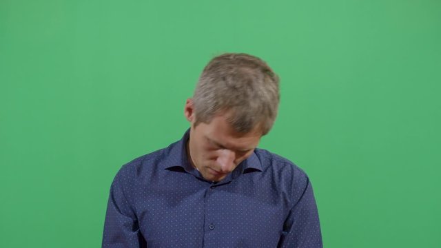 Adult Man Head Turning Like A Sign Of Stress Or Trying To Relax A Tired Body. Studio Isolated Shot Against Green Screen Background