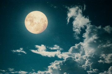 Fototapeta na wymiar Romantic night scene - Beautiful full moon with cloud in night skies. Retro style with vintage color tone.