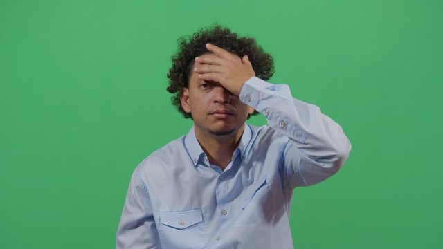 Adult Man Slapping His Forehead Suggesting Bad News Notice. Studio Isolated Shot Against Green Screen Background
