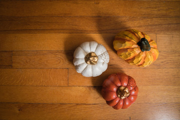 Fall pumpkins on old wooden background. Autumn background with space.