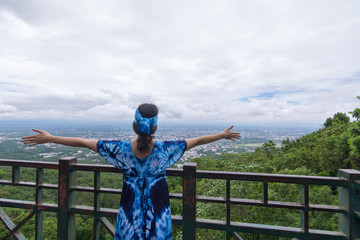 Young woman is seeing top view on a hill, Travel concept