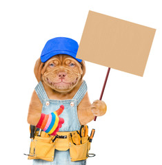 Smiling puppy worker with a blue cap with a tool belt holding a blank banner mock up on wood stick and showing thumbs up. isolated on white background