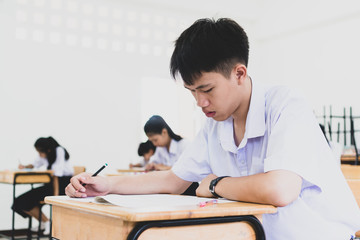teacher helping student in classroom