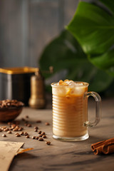 Ice coffee on a wood table with cream
