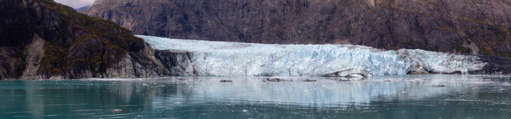 Fototapeta na wymiar Beautiful Panoramic View of Margerie Glacier in the American Mountain Landscape on the Ocean Coast during a cloudy morning in fall season. Taken in Glacier Bay National Park and Preserve, Alaska, USA.