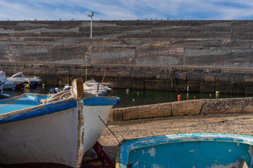 Old wooden fishing boats in a small harbor on the Canary islands - 295574849