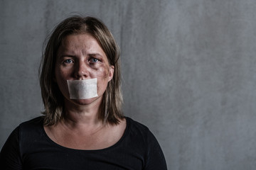 Beaten up woman victim of domestic violence and abusewith covered her mouth