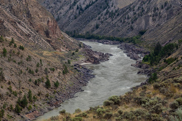Aerial Panoramic View of Fraser River running in the valley surrounded by Canadian Mountain Landscape during summer time. Taken near Lillooet, BC, Canada.