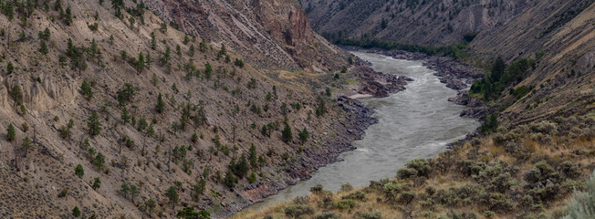 Aerial Panoramic View of Fraser River running in the valley surrounded by Canadian Mountain Landscape during summer time. Taken near Lillooet, BC, Canada.
