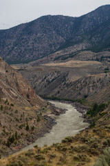 Aerial Panoramic View of Fraser River running in the valley surrounded by Canadian Mountain Landscape during summer time. Taken near Lillooet, BC, Canada.