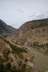Aerial Panoramic View of Fraser River running in the valley surrounded by Canadian Mountain Landscape during summer time. Taken near Lillooet, BC, Canada.