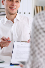 Male arm in white shirt offer contract form