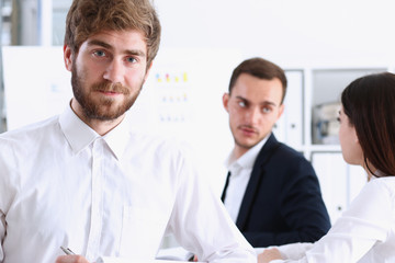 Handsome smiling bearded man in office