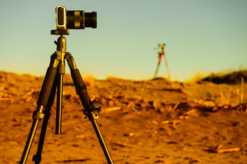 Camera on sand beach taking picture film