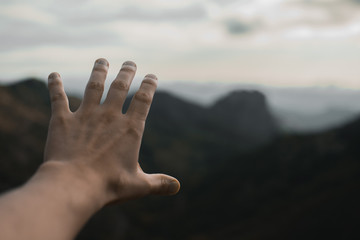 Opened hand with  a mountain at the background