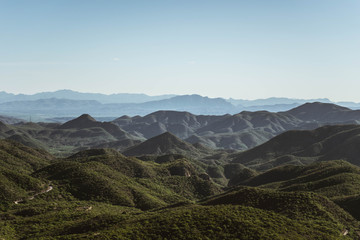 Colorful mountains far away with a clean and blue sky